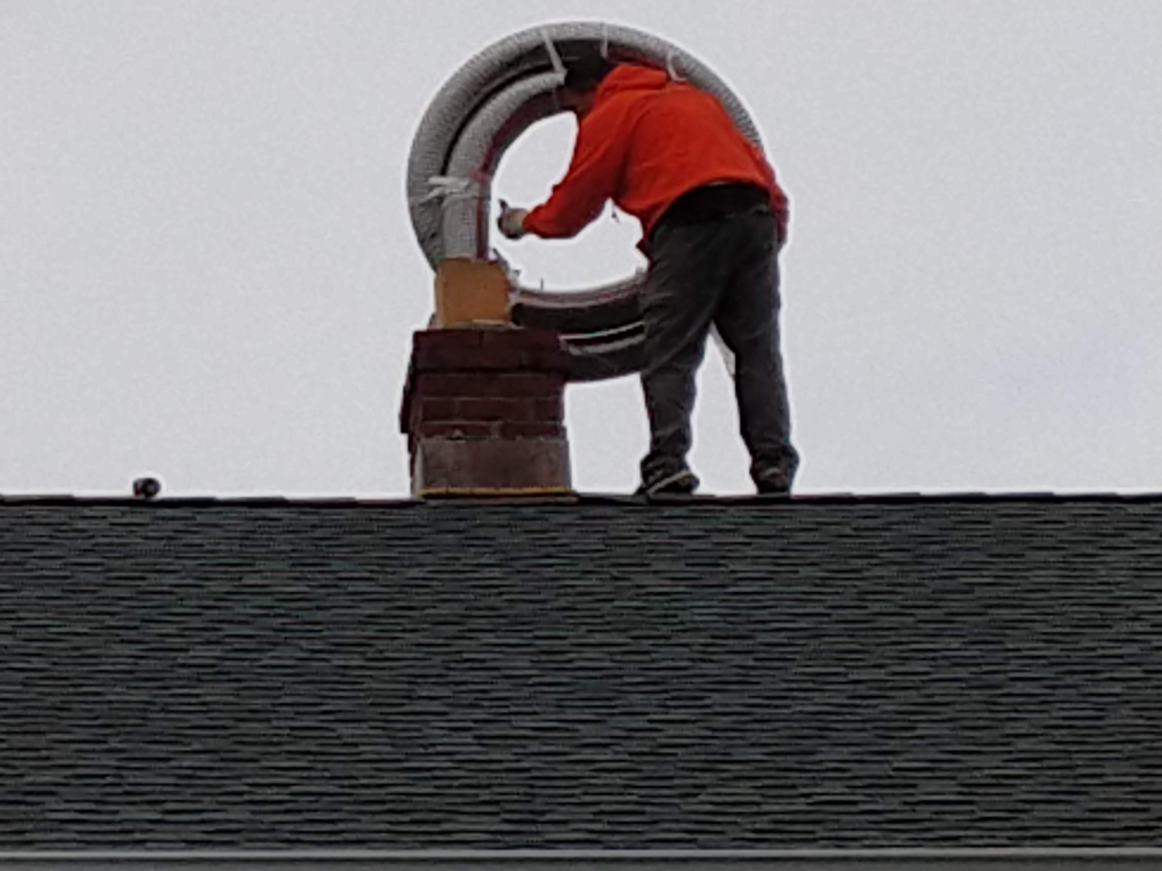 Flexible stainless chimney liner being installed in East Hampton, New York